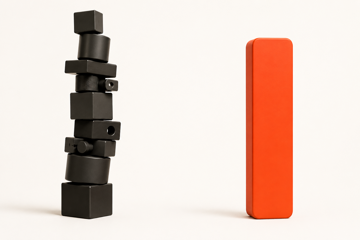 A tall stack of many mismatched pieces beside a single solid orange monolith.